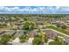 A beautiful aerial view of a well-planned community, showcasing the homes, landscaping, and nearby lake and green spaces at 2637 Yukon Cliff Dr, Ruskin, FL 33570