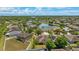 Panoramic aerial view of the community with lush trees, a tranquil lake, and well-maintained homes at 2637 Yukon Cliff Dr, Ruskin, FL 33570