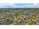Wide aerial view of the community, showing neighborhood layout with ponds and lush tree coverage at 2637 Yukon Cliff Dr, Ruskin, FL 33570