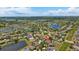 Wide aerial view of the community centered on a home with a pin drop, showing neighborhood layout and nearby lake at 2637 Yukon Cliff Dr, Ruskin, FL 33570