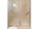 An accessible shower featuring glass doors, grab bars, and tiled walls at 2637 Yukon Cliff Dr, Ruskin, FL 33570