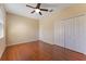Bright bedroom boasts wood floors, ceiling fan, closet and a window at 2637 Yukon Cliff Dr, Ruskin, FL 33570