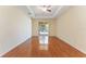 Spacious bedroom with hardwood floors, tray ceiling, ceiling fan, and sliding glass door to outdoor space at 2637 Yukon Cliff Dr, Ruskin, FL 33570