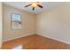 Comfortable bedroom features wood floors, a ceiling fan and a window at 2637 Yukon Cliff Dr, Ruskin, FL 33570