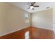 Bedroom features ceiling fan, wood floors, and a window offering natural light at 2637 Yukon Cliff Dr, Ruskin, FL 33570