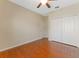 Bedroom featuring wood floors, ceiling fan, closet and a window at 2637 Yukon Cliff Dr, Ruskin, FL 33570