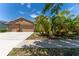 A delightful single-story home featuring a two-car garage and beautiful landscaping, including lush palm trees at 2637 Yukon Cliff Dr, Ruskin, FL 33570