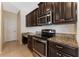 Kitchen area featuring stainless steel oven and microwave, granite counters and ample cabinet storage at 2637 Yukon Cliff Dr, Ruskin, FL 33570