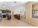Open concept kitchen featuring stainless appliances, dark cabinets and adjoining dining and living spaces at 2637 Yukon Cliff Dr, Ruskin, FL 33570