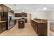 Kitchen features stainless steel appliances, granite countertops, dark cabinetry and tile flooring at 2637 Yukon Cliff Dr, Ruskin, FL 33570