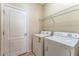 Laundry area features a washer, dryer, and wire shelving for storage at 2637 Yukon Cliff Dr, Ruskin, FL 33570
