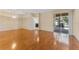 Open-concept living room boasting hardwood floors and a sliding glass door with views of the backyard at 2637 Yukon Cliff Dr, Ruskin, FL 33570
