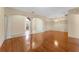 Inviting living area with hardwood floors, decorative columns, and an elegant glass front door at 2637 Yukon Cliff Dr, Ruskin, FL 33570