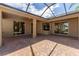 An inviting outdoor patio with brick pavers and a screened enclosure, perfect for relaxing or entertaining guests at 2637 Yukon Cliff Dr, Ruskin, FL 33570