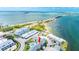 Stunning aerial view showcasing coastal community, pool, and ocean access, epitomizing waterfront living at 2643 St Josephs W Dr, Dunedin, FL 34698