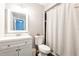 Modern bathroom featuring dark tiled shower with decorative stripe, a modern vanity and updated fixtures at 2643 St Josephs W Dr, Dunedin, FL 34698