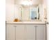 Well-lit bathroom with granite counters, generous cabinetry, and a tub-shower combo offers a blend of style and functionality at 2643 St Josephs W Dr, Dunedin, FL 34698