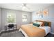 Sunlit bedroom featuring an accent wall, a decorative rug and bright windows creating a stylish and welcoming atmosphere at 2643 St Josephs W Dr, Dunedin, FL 34698