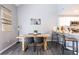 Bright dining area with wood table and modern chairs next to the open kitchen at 2643 St Josephs W Dr, Dunedin, FL 34698