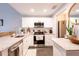 Modern kitchen featuring stainless steel appliances, white cabinetry and granite countertops at 2643 St Josephs W Dr, Dunedin, FL 34698