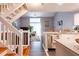 Modern kitchen with stainless steel appliances, island seating, and adjacent living area at 2643 St Josephs W Dr, Dunedin, FL 34698