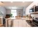Bright kitchen featuring stone countertops, stainless steel appliances, and an open design at 2643 St Josephs W Dr, Dunedin, FL 34698