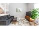 Cozy living room featuring a comfortable sofa, stylish rug and modern decor at 2643 St Josephs W Dr, Dunedin, FL 34698