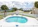 Enjoy the community pool with a charming fence, palm trees, and lounging area for ultimate relaxation at 2643 St Josephs W Dr, Dunedin, FL 34698
