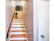 Staircase leading to the upper level with wooden steps and a neutral color scheme at 2643 St Josephs W Dr, Dunedin, FL 34698