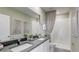 Bathroom with double sinks, a large mirror, and a shower with a gray curtain at 31326 Ancient Sage Rd, Wesley Chapel, FL 33545