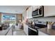 Modern kitchen with white cabinets, stainless steel appliances, open to the living room at 31326 Ancient Sage Rd, Wesley Chapel, FL 33545
