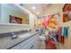 Bright bathroom with granite countertops, a white vanity, and colorful flower shower curtain at 3174 Eagles Landing W Cir # 58, Clearwater, FL 33761