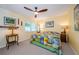 The bedroom boasts natural light, a colorful quilt, a ceiling fan, and side tables at 3174 Eagles Landing W Cir # 58, Clearwater, FL 33761