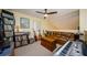 The bonus room features a leather sofa, instruments, and neutral carpet at 3174 Eagles Landing W Cir # 58, Clearwater, FL 33761