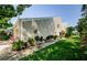 Side view of a home, featuring siding, plants along the walkway, and well-maintained landscaping at 3174 Eagles Landing W Cir # 58, Clearwater, FL 33761