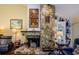 Close up on a stone fireplace with mantle, decorative stained glass, and built in shelving at 3174 Eagles Landing W Cir # 58, Clearwater, FL 33761