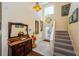 Inviting foyer with high ceilings, decorative mirror, and carpeted stairs leading to the second floor at 3174 Eagles Landing W Cir # 58, Clearwater, FL 33761
