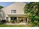 Inviting home exterior with a covered porch, lush landscaping, and large windows at 3174 Eagles Landing W Cir # 58, Clearwater, FL 33761