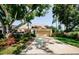 Charming home featuring lush landscaping, a driveway, and an attached two-car garage at 3174 Eagles Landing W Cir # 58, Clearwater, FL 33761