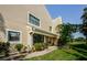 Inviting home exterior with a covered porch, lush landscaping, and large windows at 3174 Eagles Landing W Cir # 58, Clearwater, FL 33761