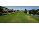 Beautiful view of golf course with pond and lush greenery surrounding homes, creating a serene setting at 3174 Eagles Landing W Cir # 58, Clearwater, FL 33761
