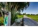 A view of golf course tee box with distance marker and palm trees along the green fairway at 3174 Eagles Landing W Cir # 58, Clearwater, FL 33761