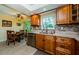 Well-appointed kitchen with wood cabinets, stainless steel appliances, and adjacent dining area at 3174 Eagles Landing W Cir # 58, Clearwater, FL 33761