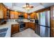 Updated kitchen with stainless steel appliances, wood cabinets, granite countertops, and tile floors at 3174 Eagles Landing W Cir # 58, Clearwater, FL 33761