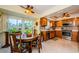 Cozy breakfast nook features garden view adjacent to the kitchen with wood cabinets and granite counters at 3174 Eagles Landing W Cir # 58, Clearwater, FL 33761