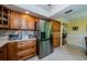 Bright kitchen features wood cabinets, granite counters, stainless steel appliances, and tile backsplash at 3174 Eagles Landing W Cir # 58, Clearwater, FL 33761
