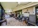 Spacious covered lanai with fan, multiple seating areas, and view of the garden at 3174 Eagles Landing W Cir # 58, Clearwater, FL 33761