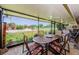 Screened lanai with dining table and chairs offering views of the lush landscaping at 3174 Eagles Landing W Cir # 58, Clearwater, FL 33761