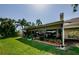 Covered lanai featuring a seating area, plants, and a view of the landscaped backyard at 3174 Eagles Landing W Cir # 58, Clearwater, FL 33761
