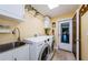 Well-equipped laundry room with modern washer, dryer, sink, cabinets, and convenient hanging rack at 3174 Eagles Landing W Cir # 58, Clearwater, FL 33761